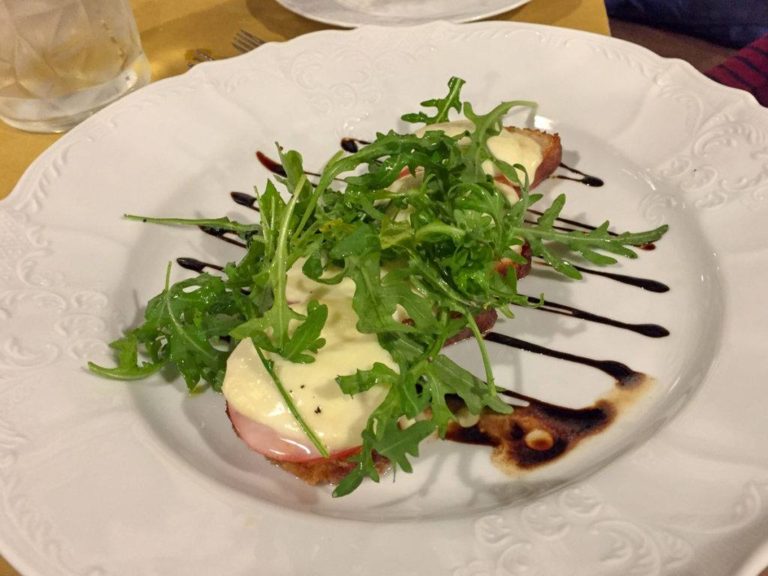Bruschetta with marinated eggplant, tomatoes, mozzarella, and rucola